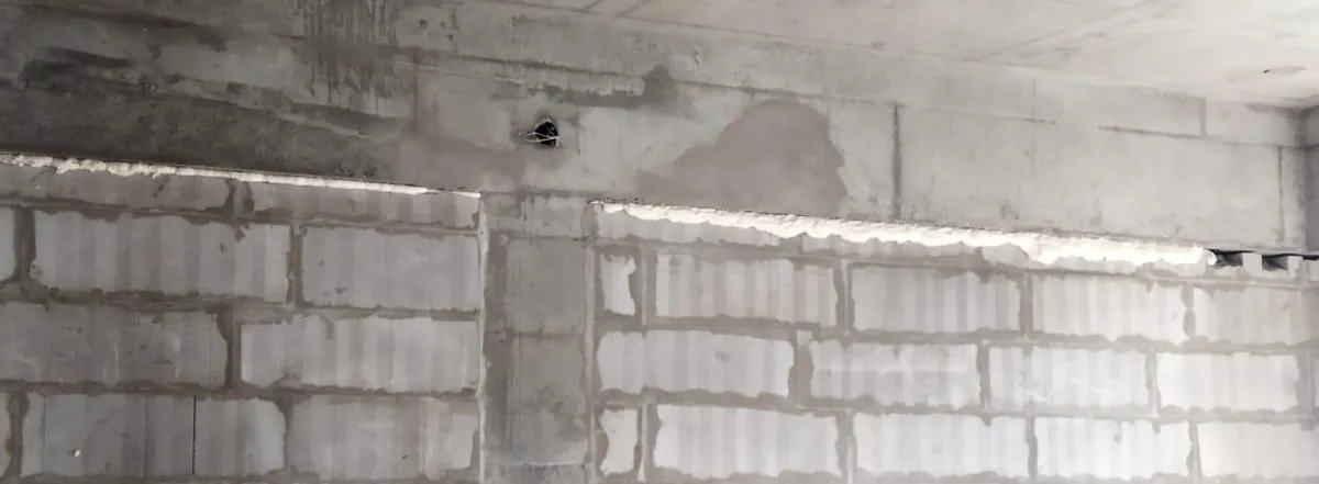 Cured MULTIFOAM along the top of a block wall, under an RCC beam, on a building site