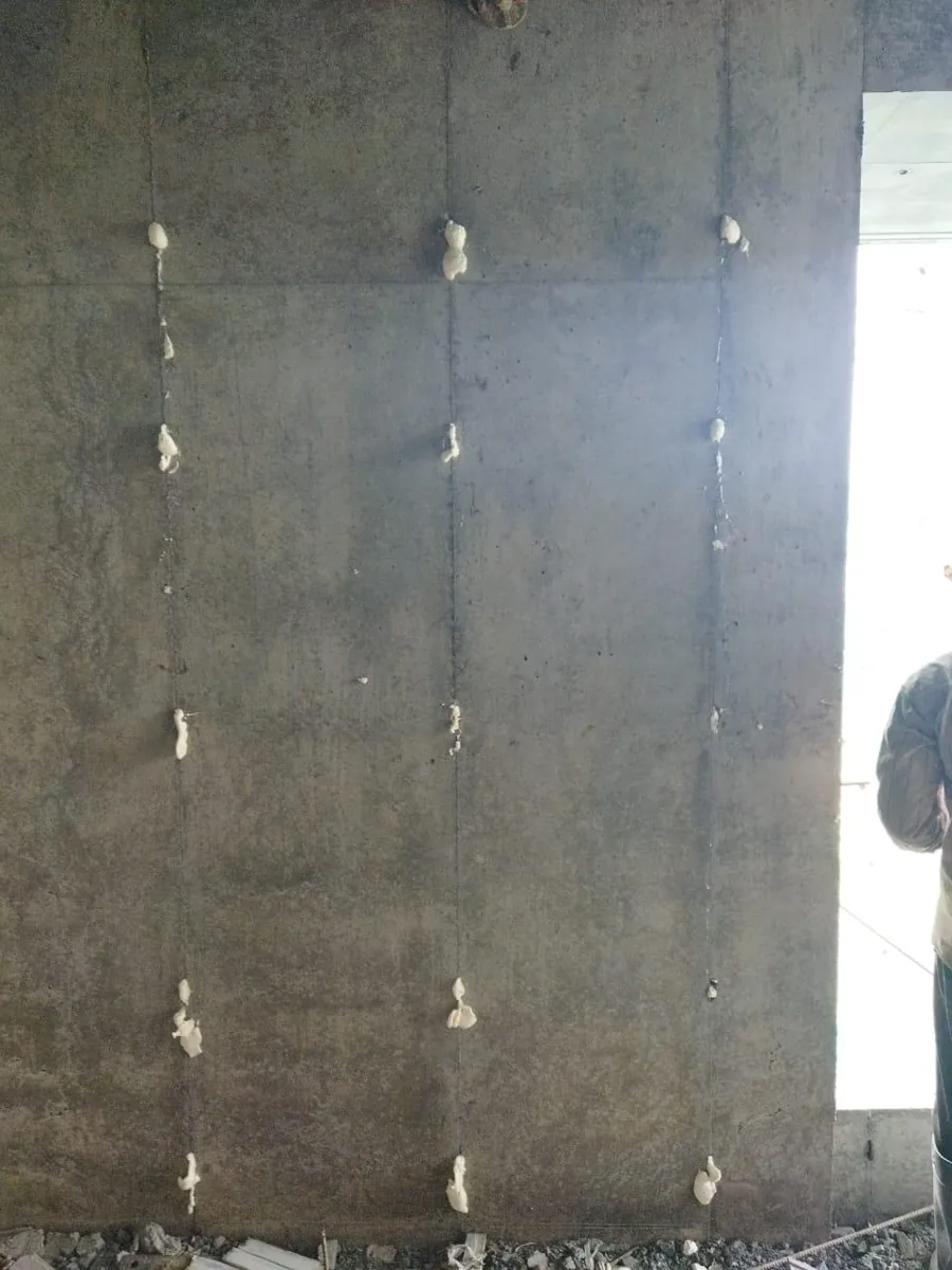 Rows of tie-rod holes in a Mivan RCC wall, each filled with MULTIFOAM